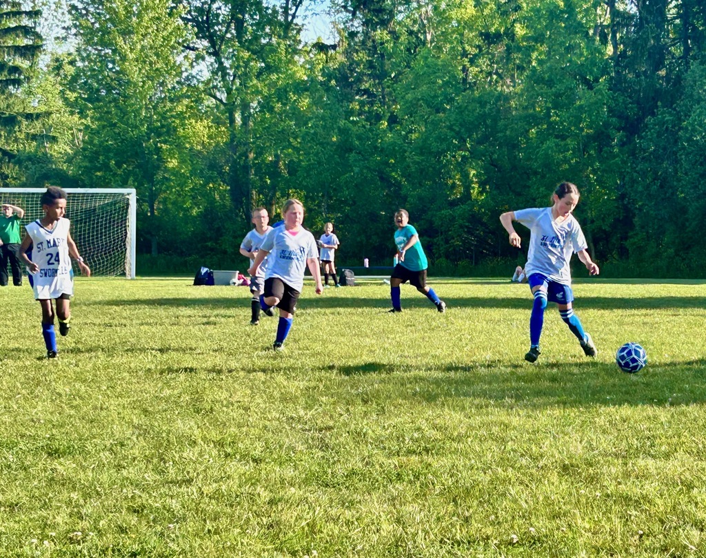 SMS grade 3 & 4 soccer players on the field during their last game of the season