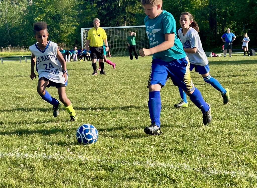 SMS grade 3 & 4 soccer players on the field during their last game of the season