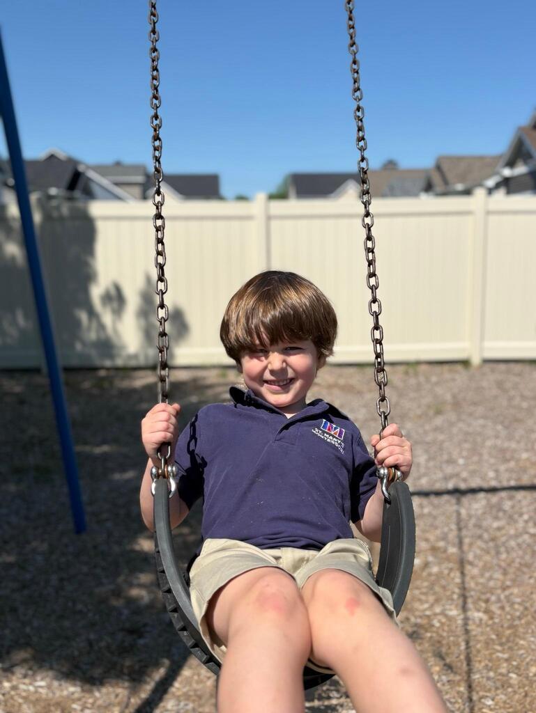 Child plays on swingset
