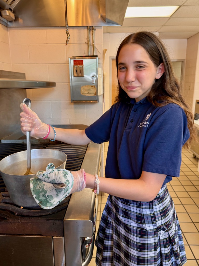 Student preparing buttered noodles in the school cafeteria