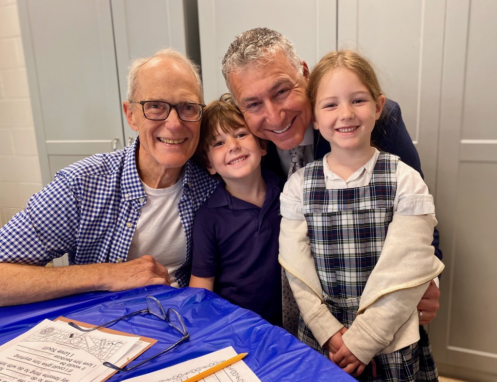 SMS students posing with their dads or grandpas at Donuts with Dads