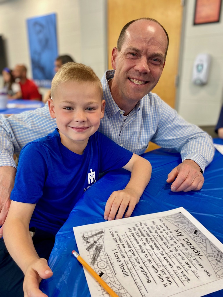 SMS students posing with their dads or grandpas at Donuts with Dads