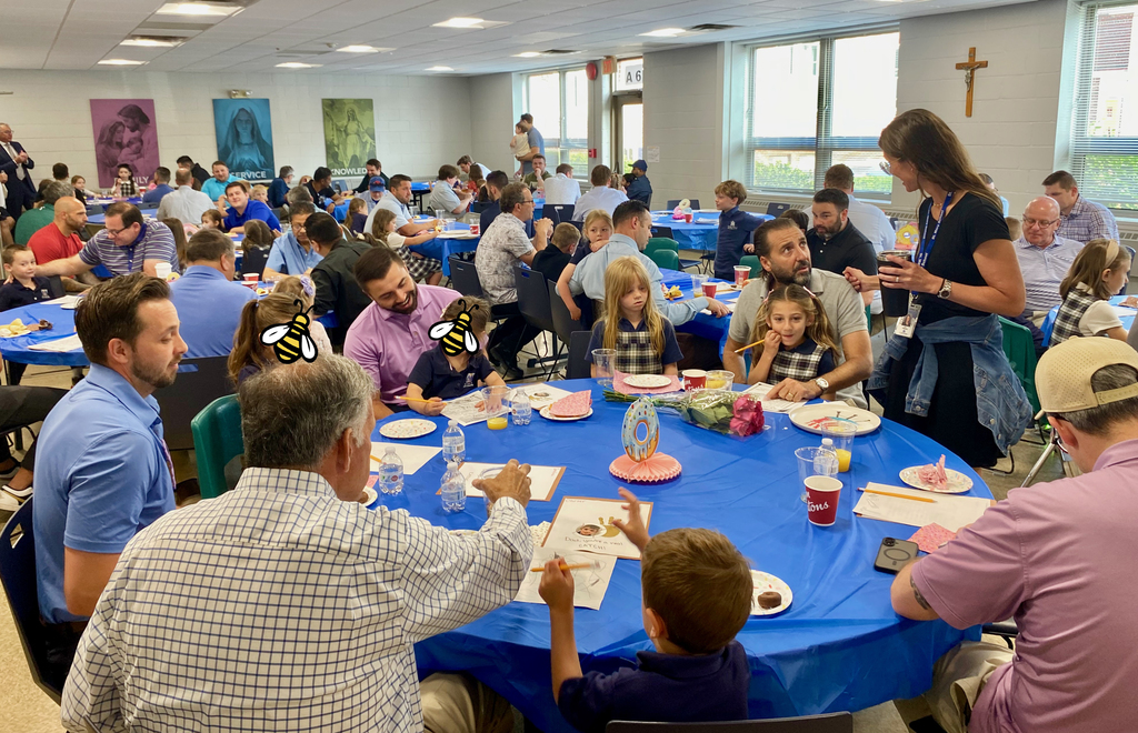 SMS students posing with their dads or grandpas at Donuts with Dads
