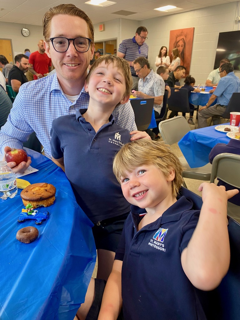SMS students posing with their dads or grandpas at Donuts with Dads