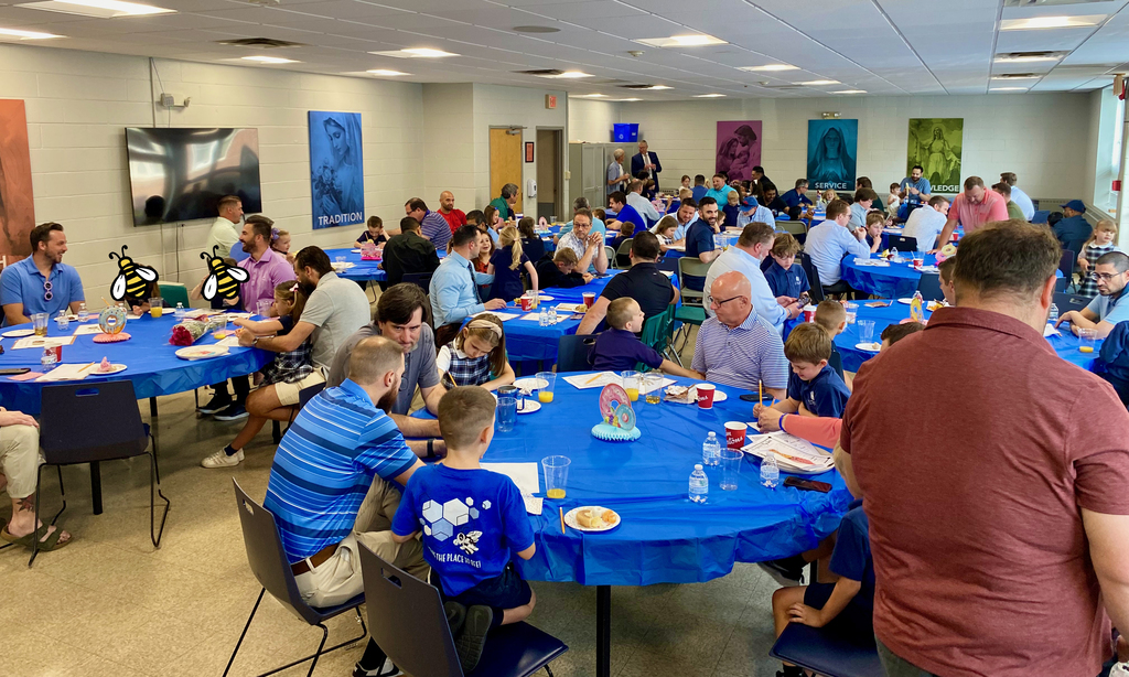 SMS students posing with their dads or grandpas at Donuts with Dads