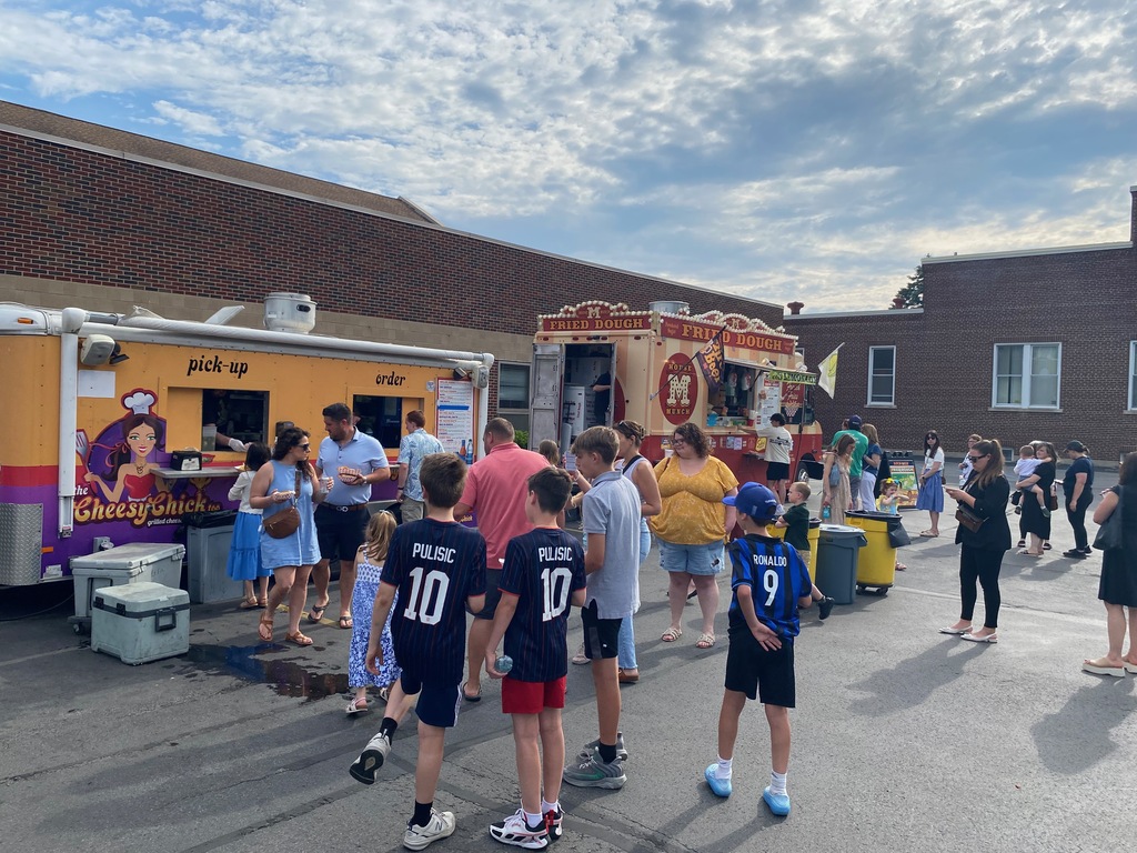 People lined up to get food from food trucks