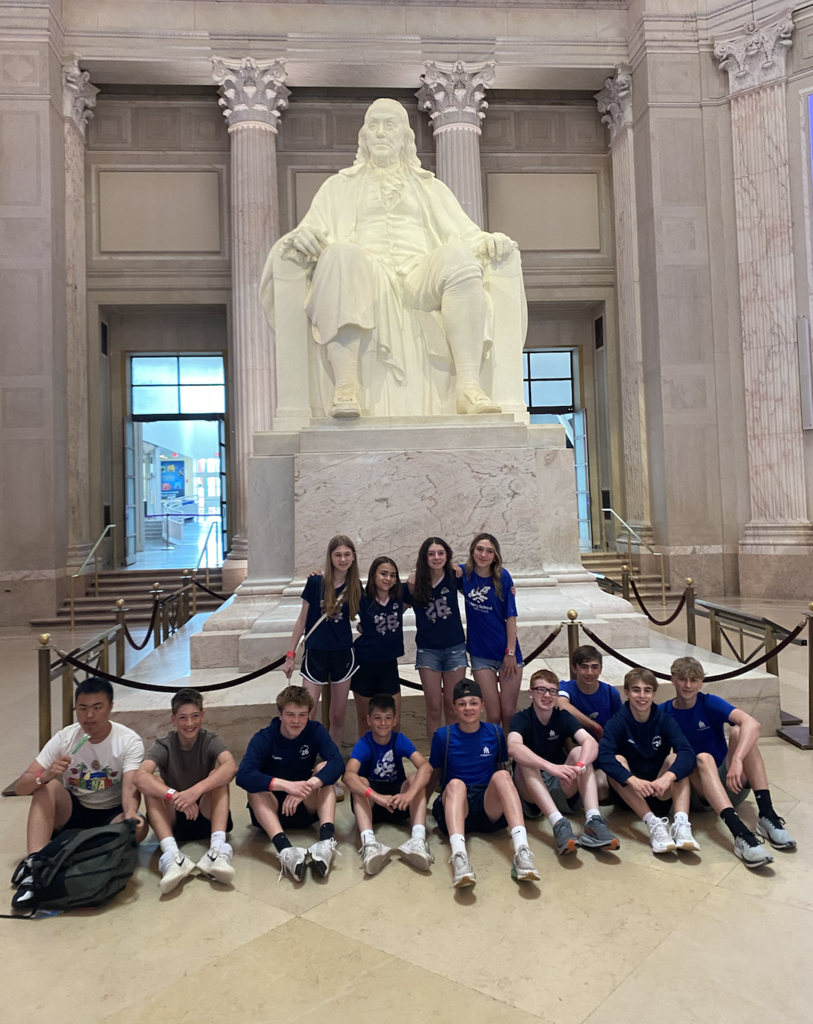 Photos from the 8th grade class trip featuring the whole class in front of Philadelphia landmarks
