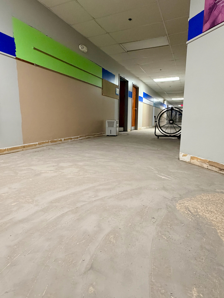 In process photos of the renovation of the school flooring in the basement