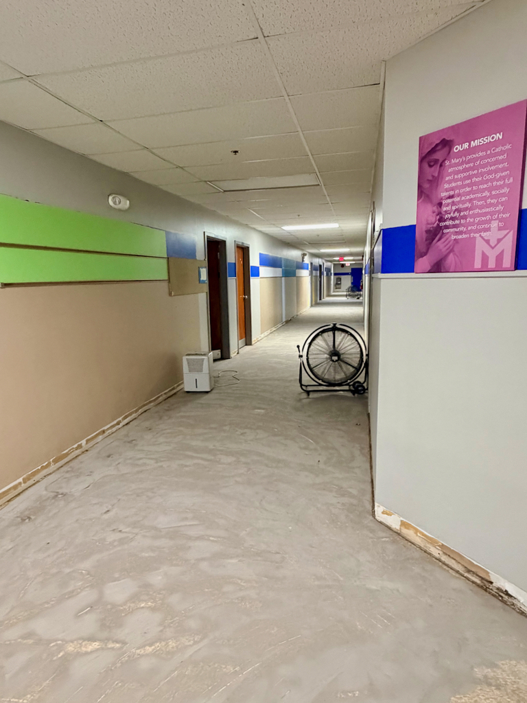 In process photos of the renovation of the school flooring in the basement