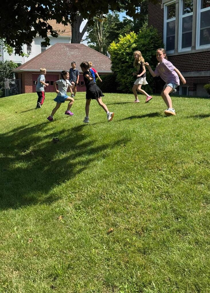 students playing outside on the grass