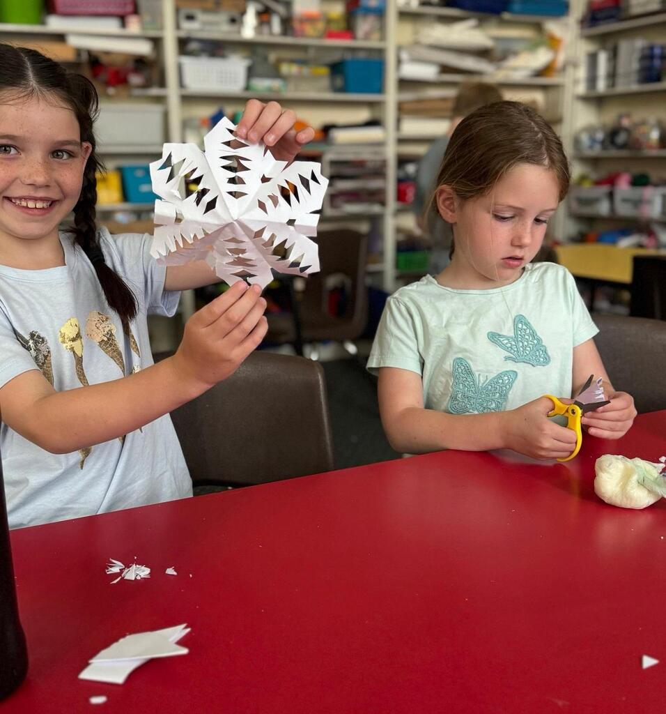 cutting out paper snowflakes