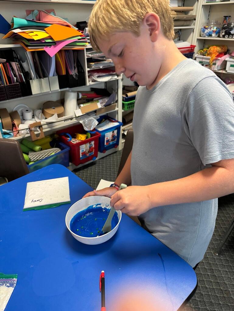students make slime at chemistry themed summer day camp