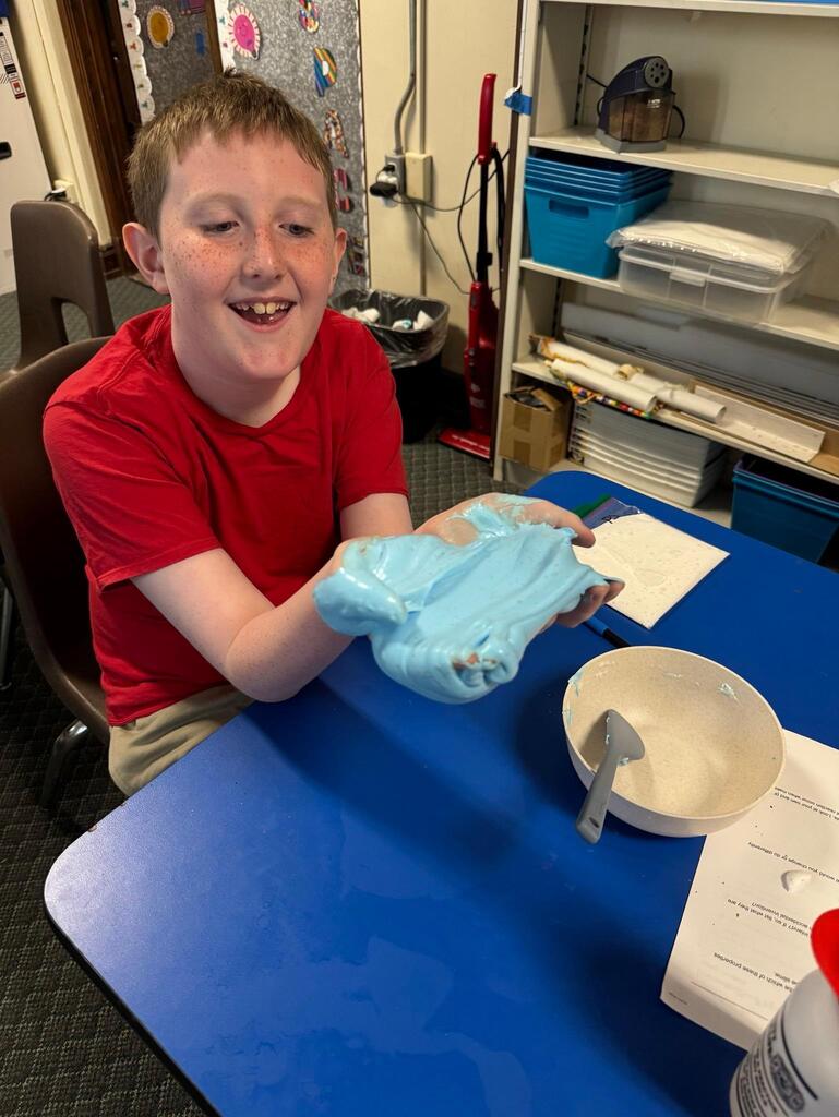 students make slime at chemistry themed summer day camp