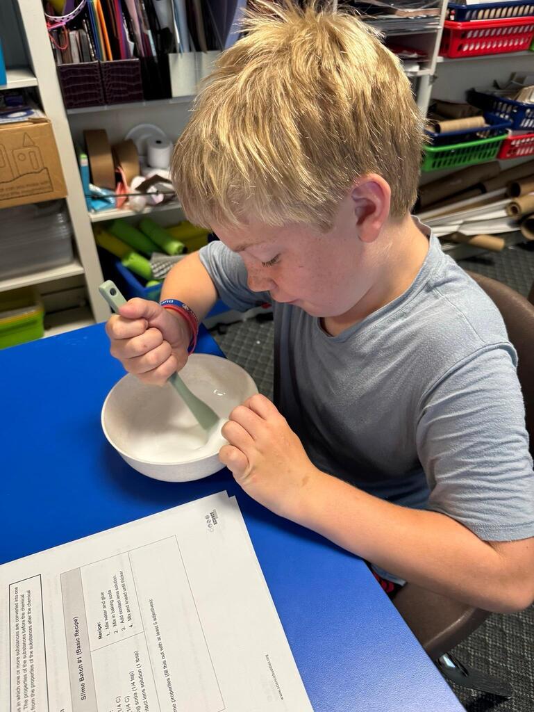 students make slime at chemistry themed summer day camp
