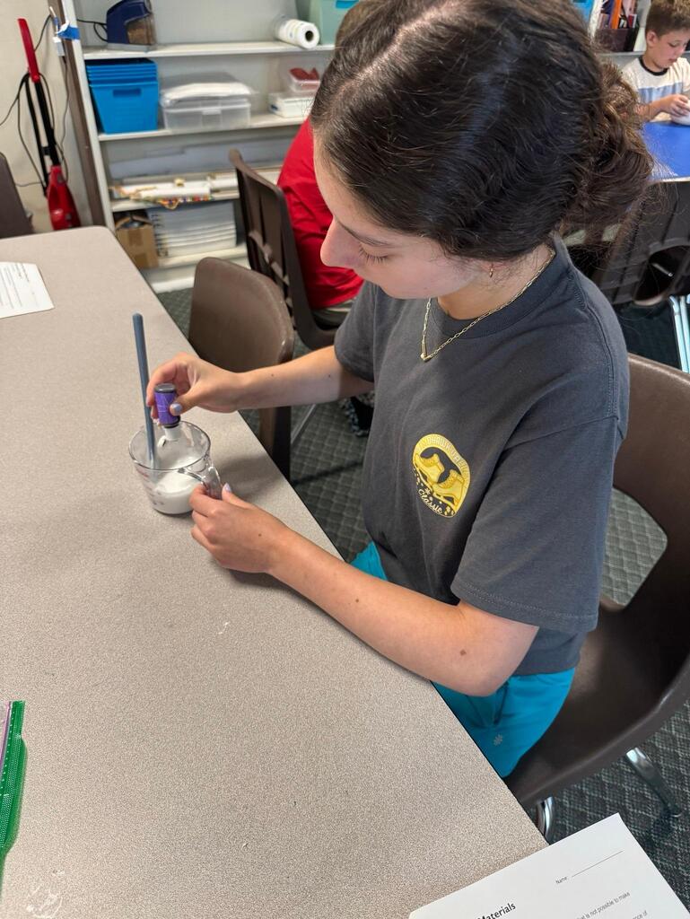 students make slime at chemistry themed summer day camp