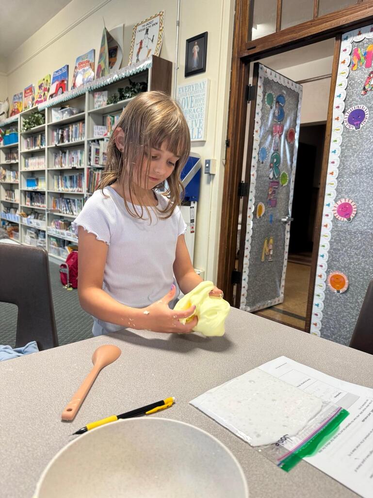 students make slime at chemistry themed summer day camp