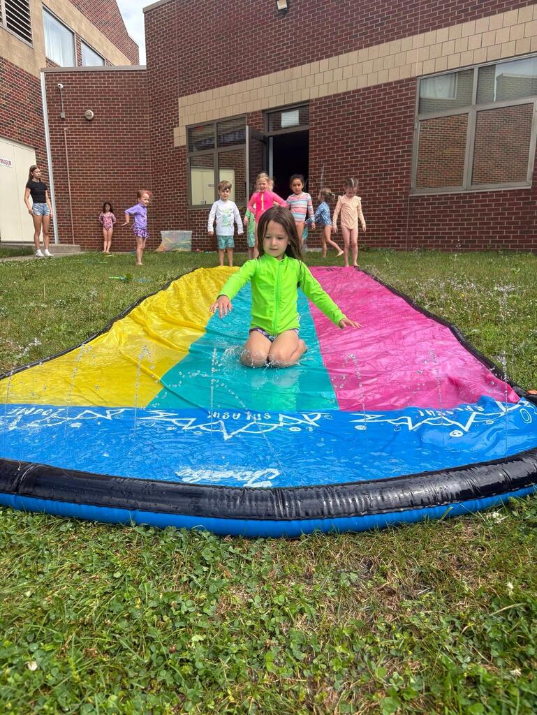 child on a slip and slide
