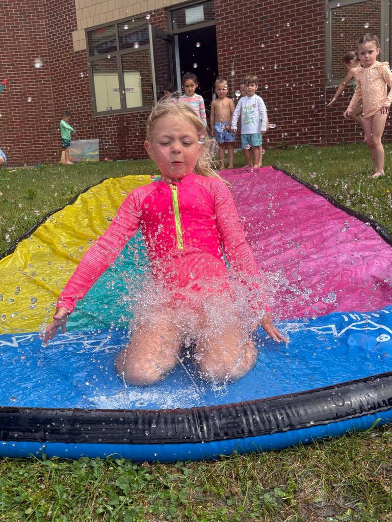 child on a slip and slide