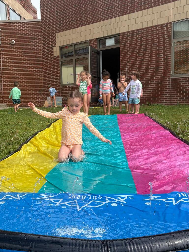 child on a slip and slide