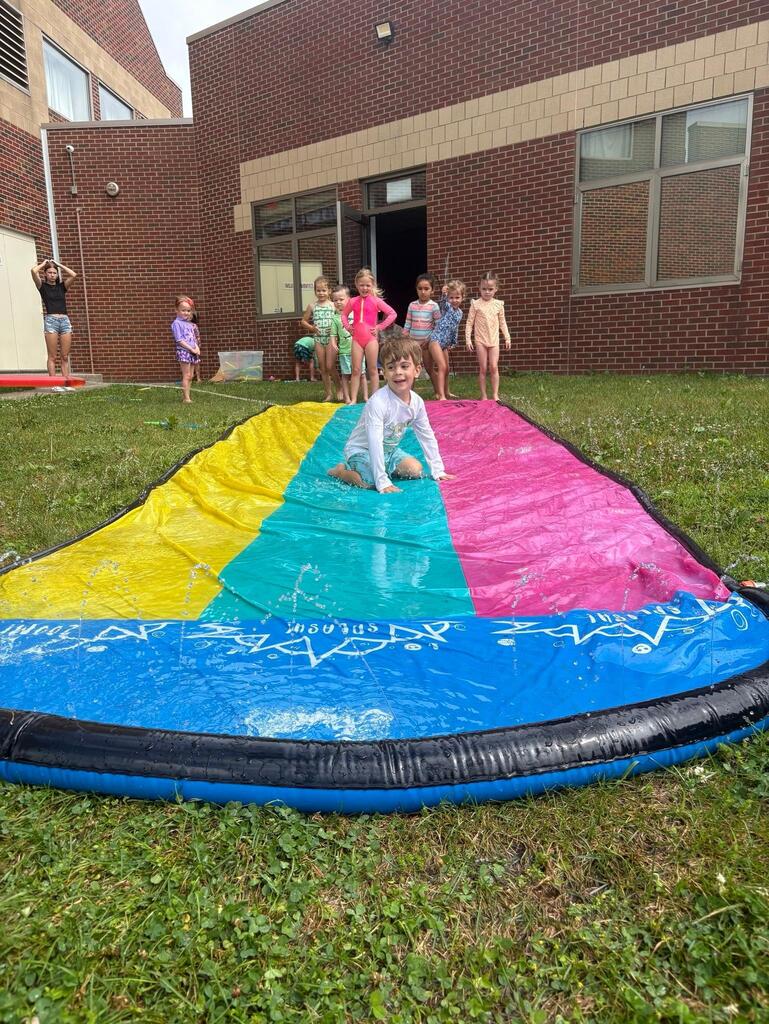 child on a slip and slide
