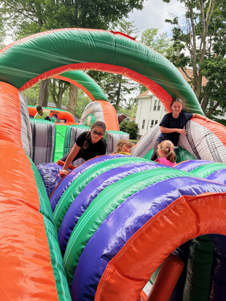Students playing in a large bounce house