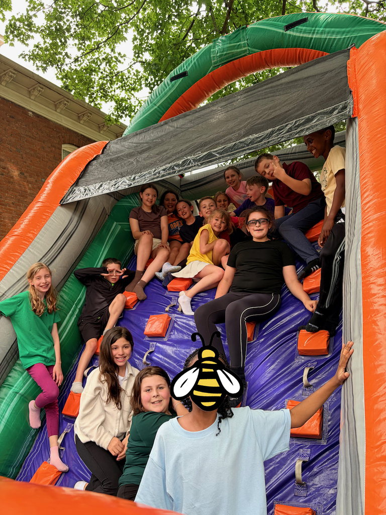Students playing in a large bounce house