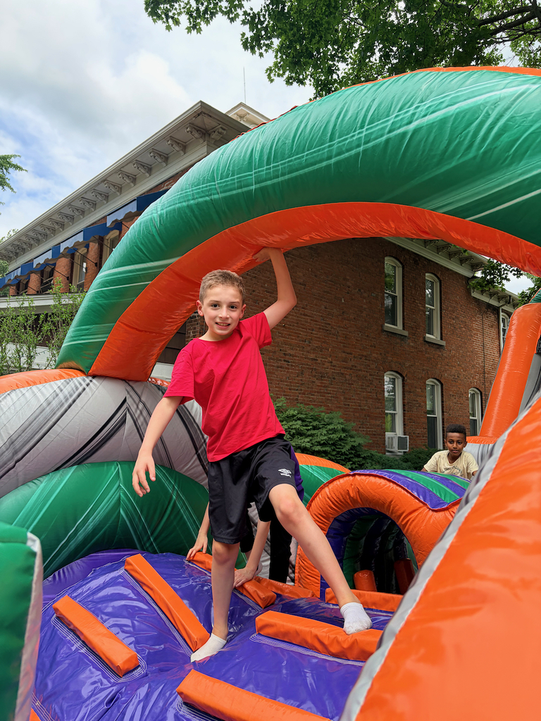 Students playing in a large bounce house