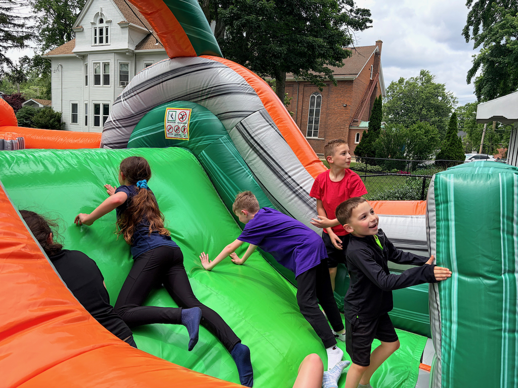 Students playing in a large bounce house