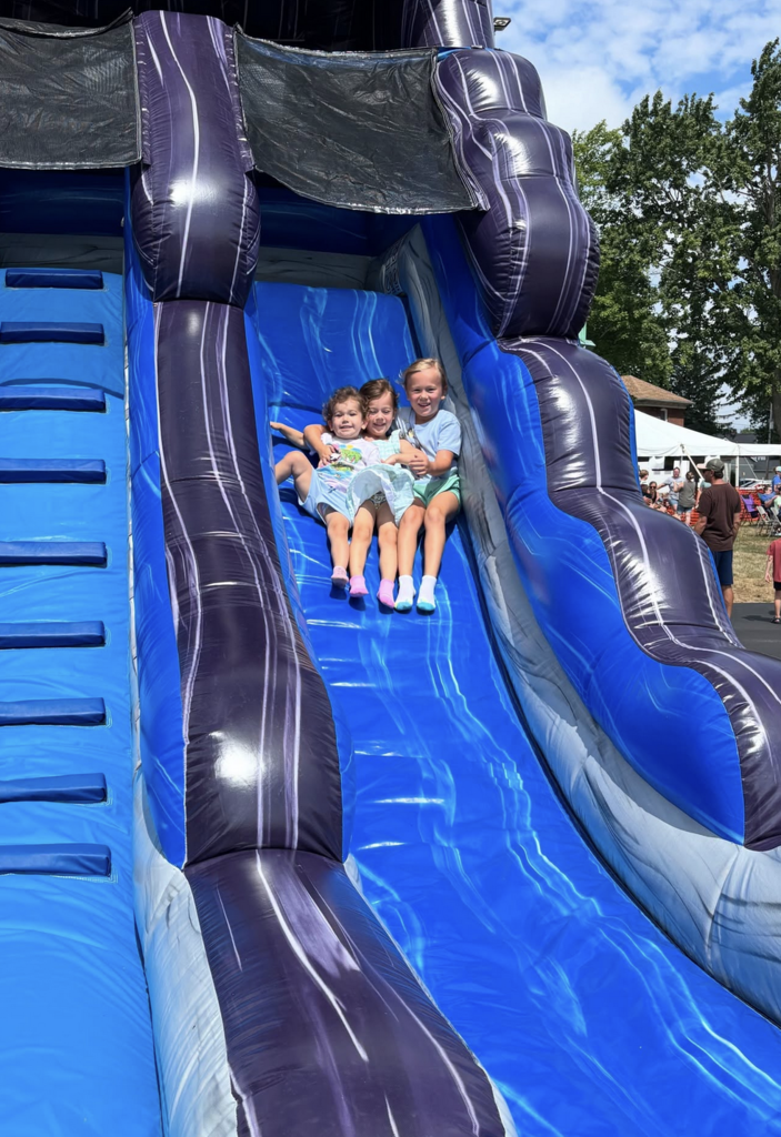 kids on an inflatable slide
