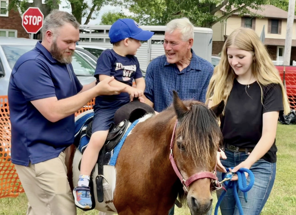 child taking a pony ride