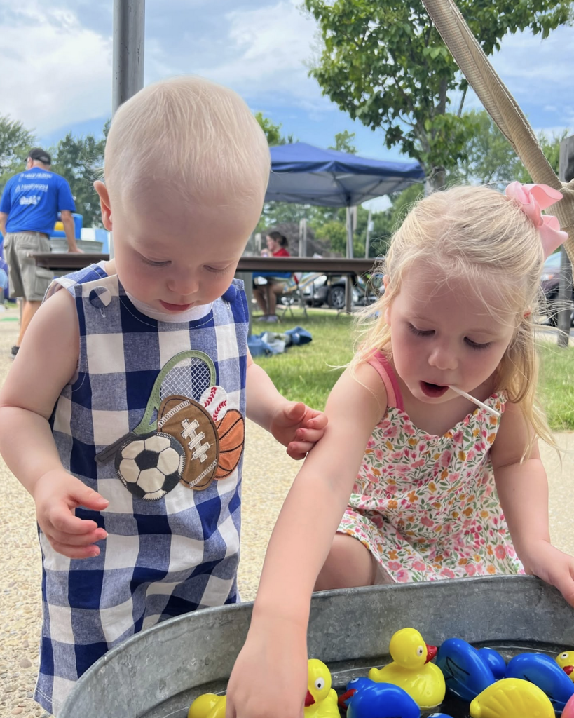young kids playing a carnival game