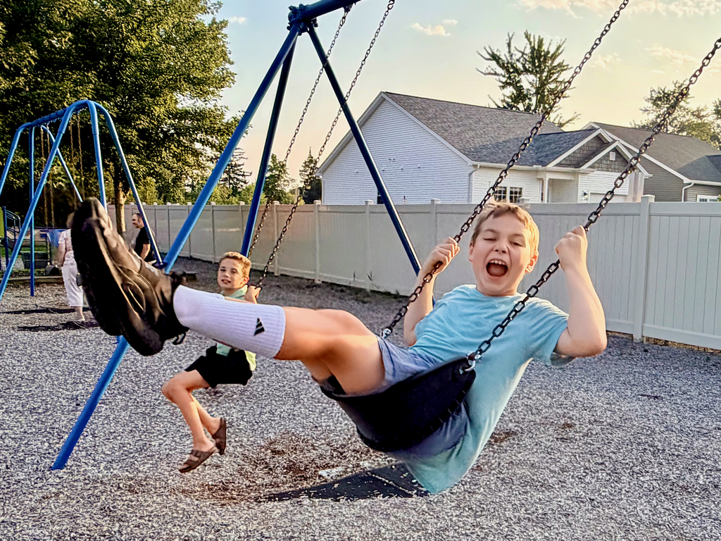Schhol age boys on swings