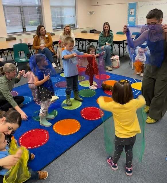 photo of children interacting with scarves