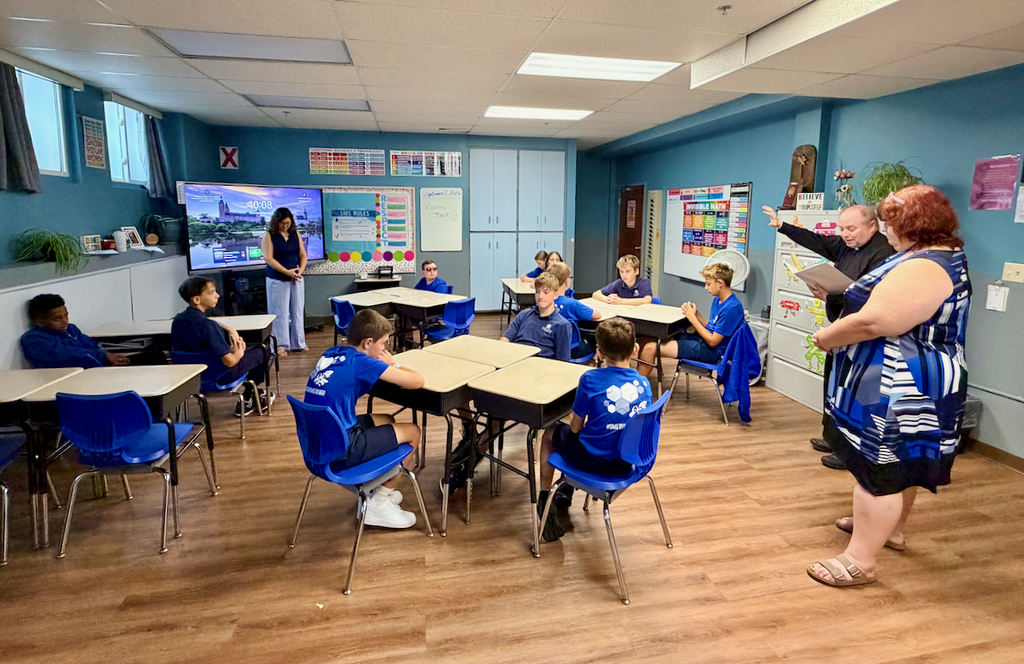 Father Tom & principal visit classrooms for back to school blessing