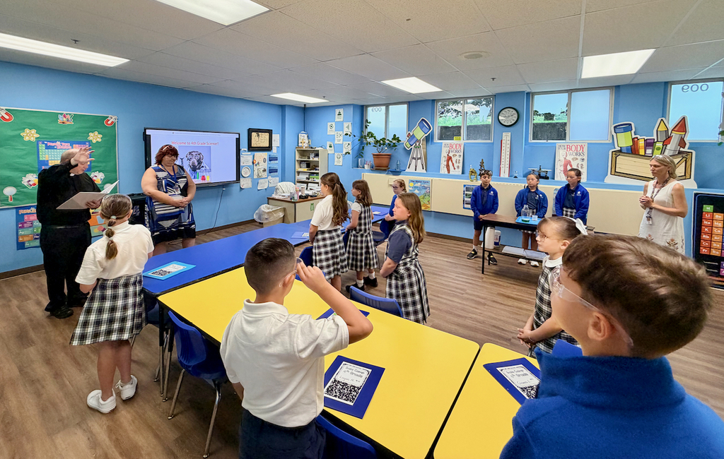 Father Tom & principal visit classrooms for back to school blessing
