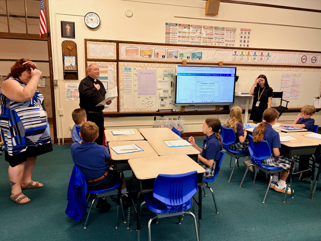Father Tom & principal visit classrooms for back to school blessing