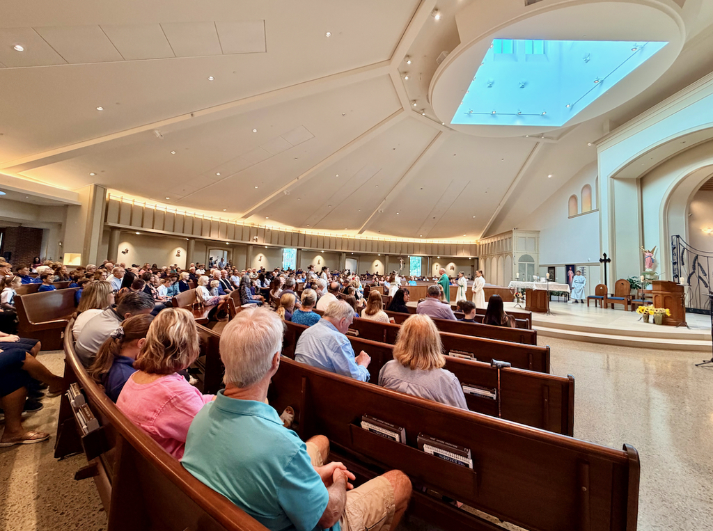 grandparents sitting pews at mass with students