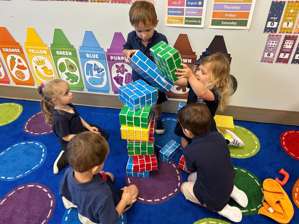 PreK students build a block tower