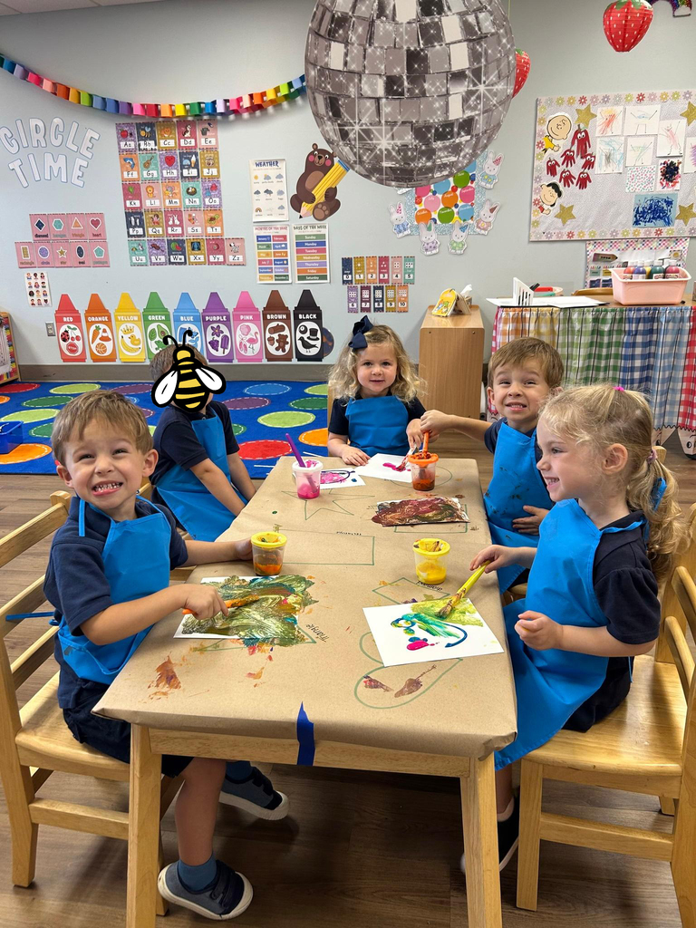 prek students paint with smocks on