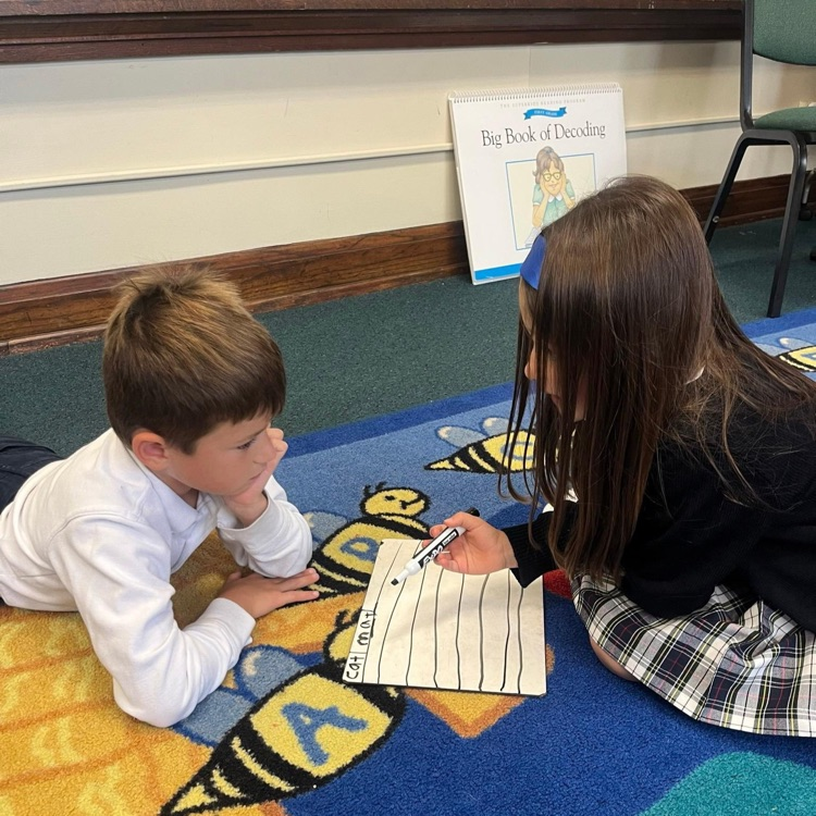 students working together on carpet