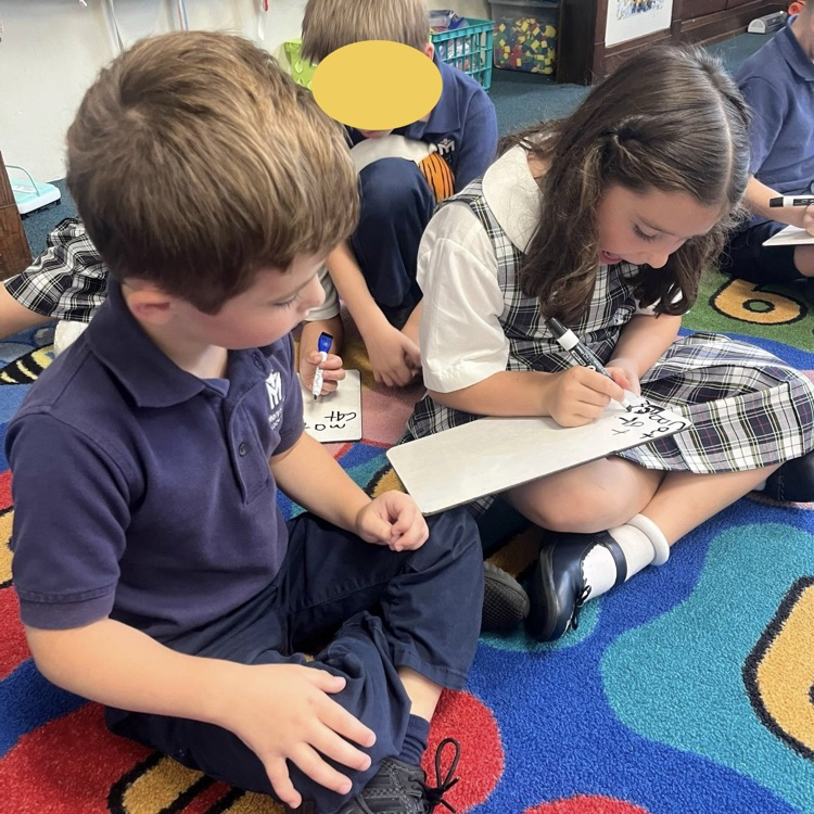 student sitting on carpet and working together