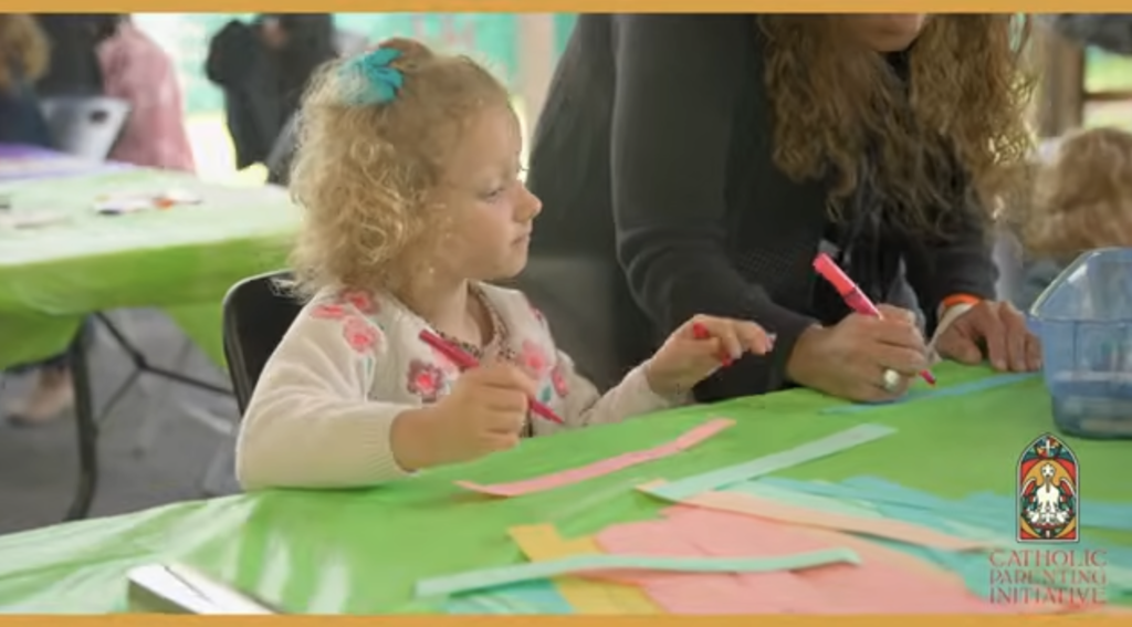 Little girl coloring at a table