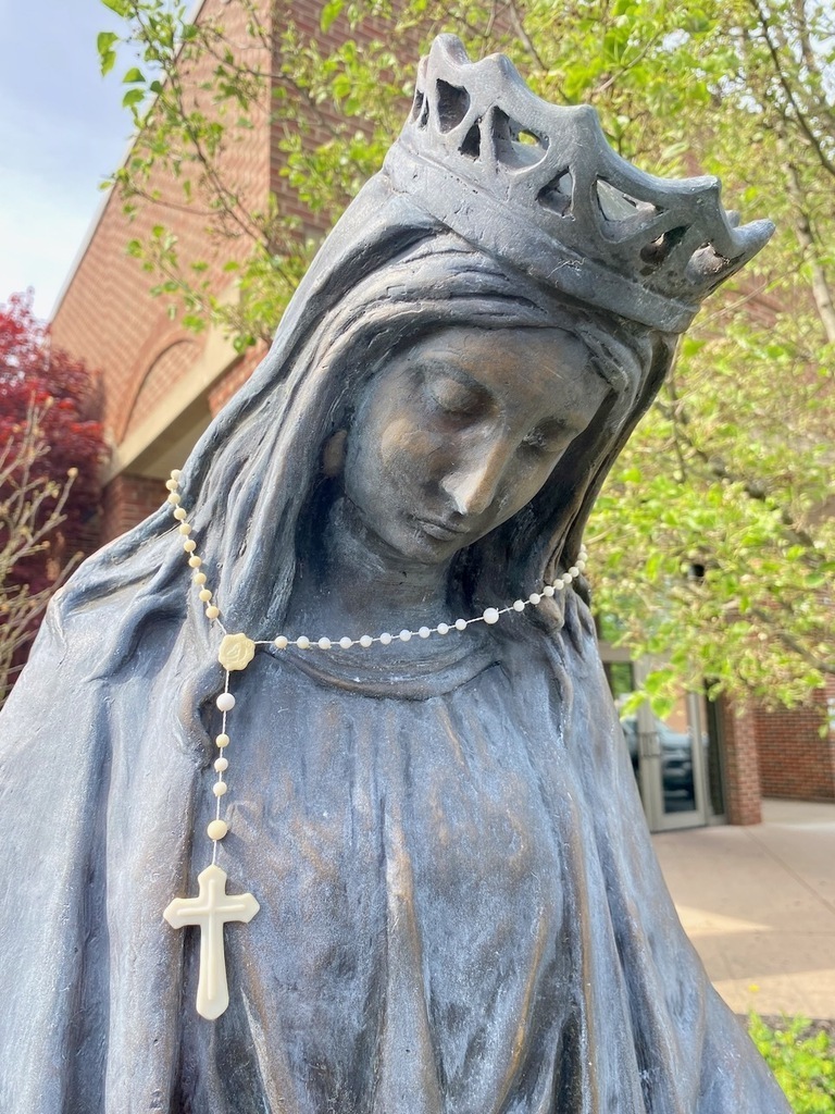 Mary statue with rosary around neck