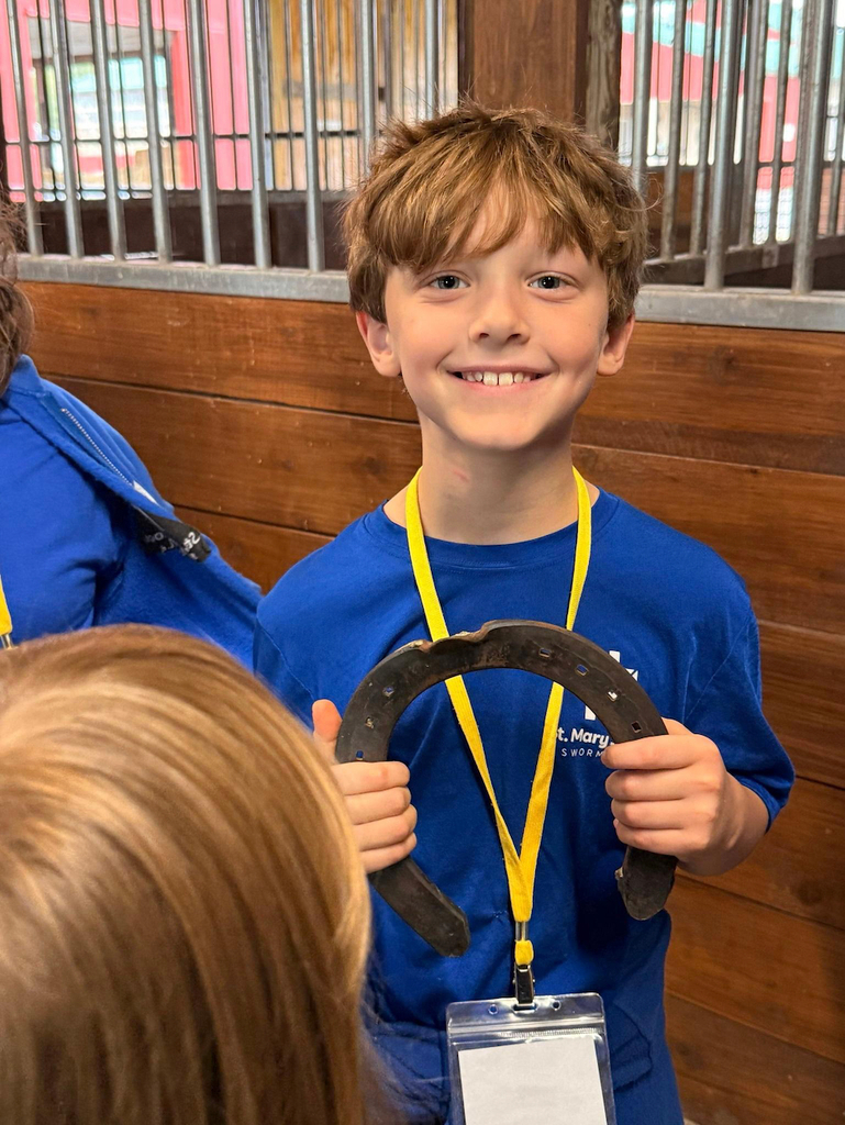 boy holding a horse shoe