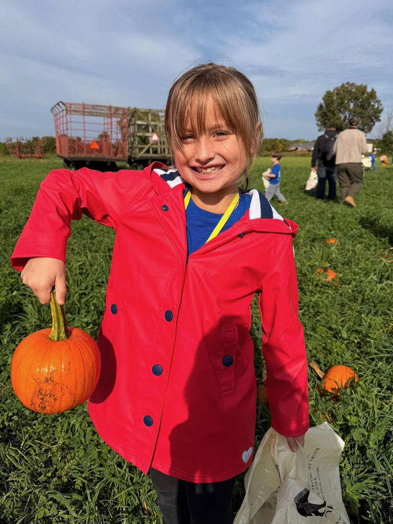 girl picking a pumpkin