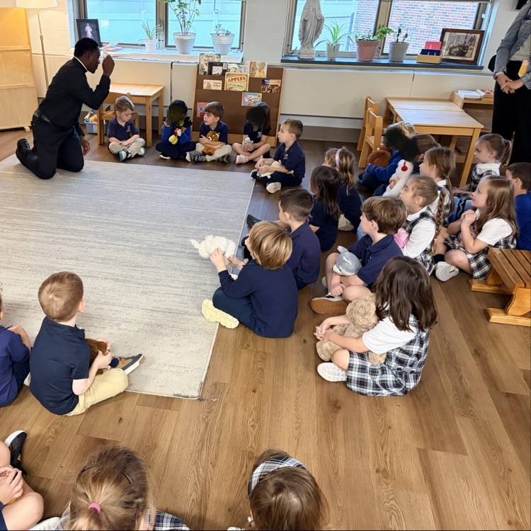 Father Peter blesses students with holy water