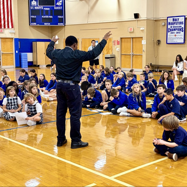 Father Peter blesses students with holy water
