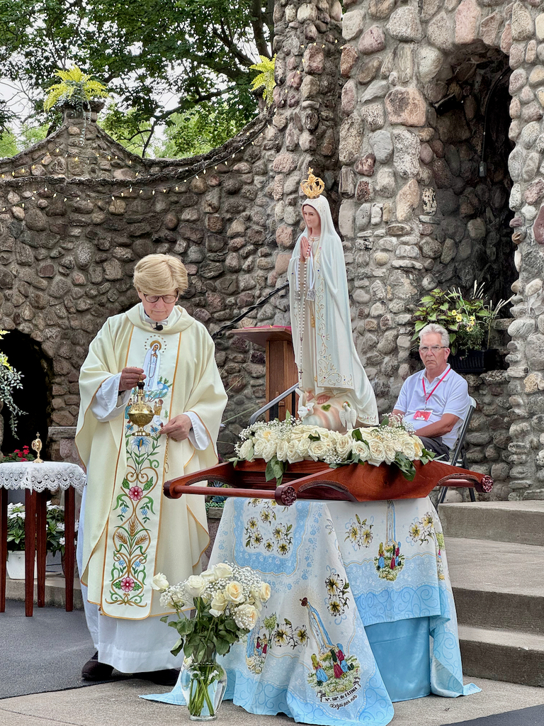 Priest with Our Lady of Fatima statue