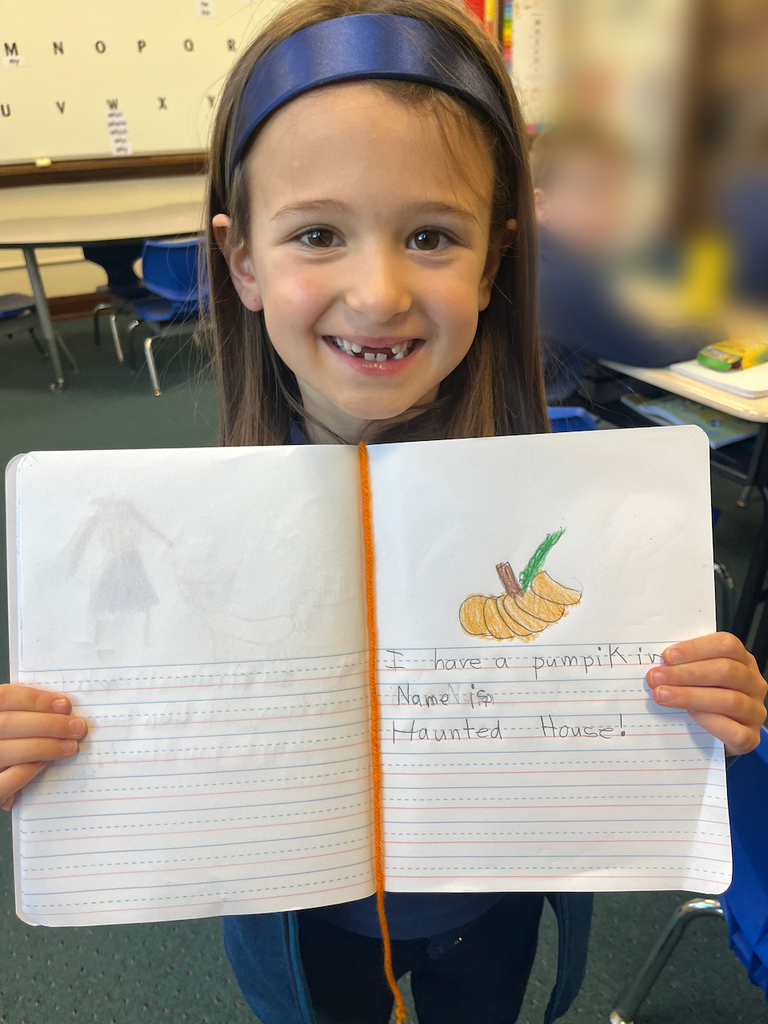 student posing with journal