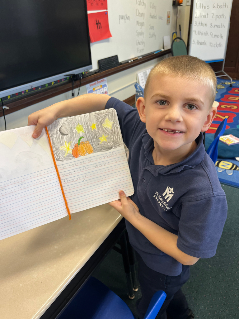 student posing with journal